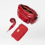 Red handbag with a matching pouch and strap on a white background